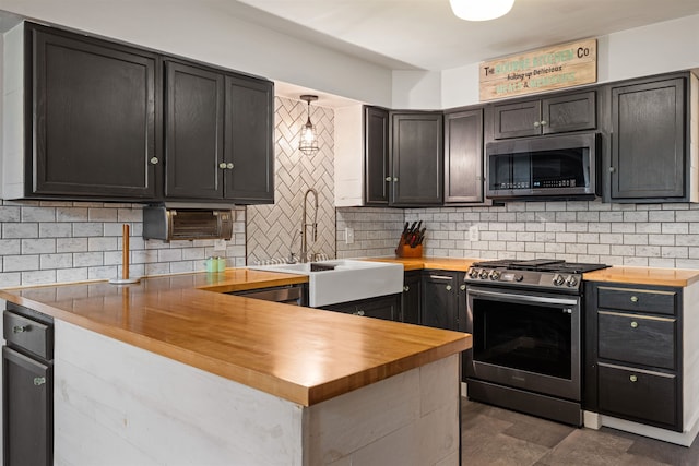 331 Holly Ln, Erma, NJ 08204 - kitchen with backsplash, a sink, a peninsula, butcher block countertops, and appliances with stainless steel finishes
