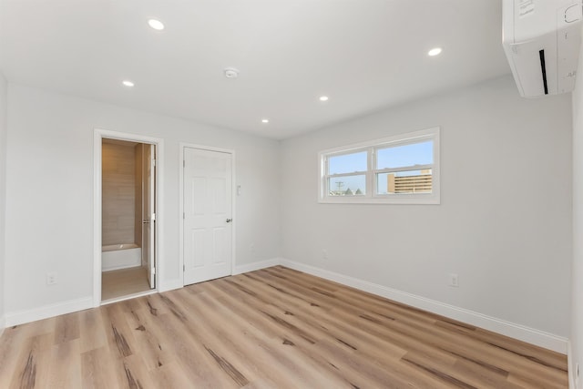 2001 Surf Ave Unit 11, North Wildwood, NJ 08260 - unfurnished bedroom with light wood finished floors, recessed lighting, ensuite bathroom, and a wall mounted AC