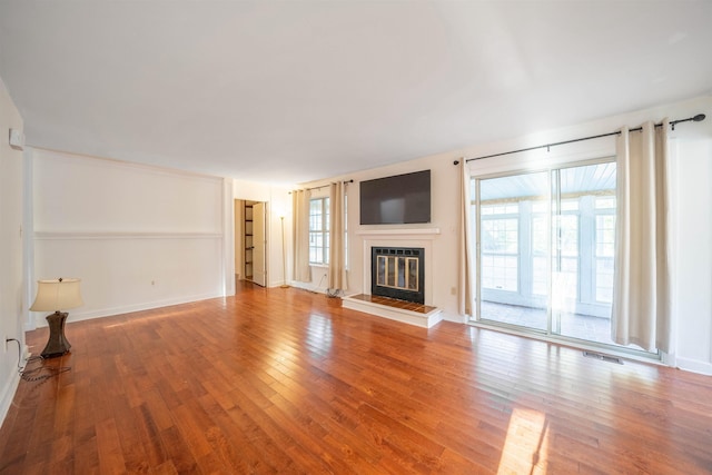 unfurnished living room with hardwood / wood-style floors and a healthy amount of sunlight