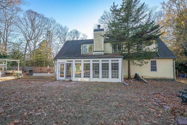 rear view of house featuring a deck and a sunroom