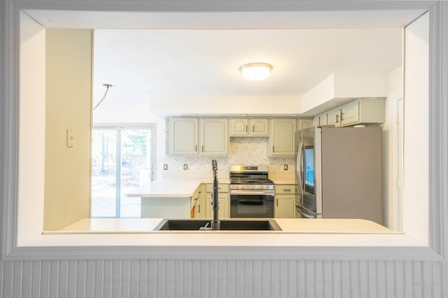 kitchen featuring decorative backsplash, appliances with stainless steel finishes, and sink