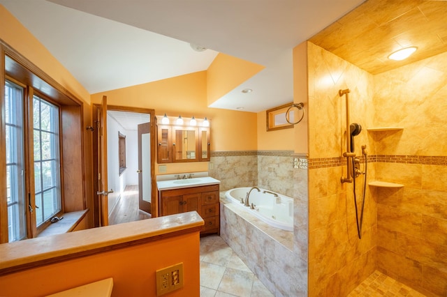 bathroom with french doors, tile patterned flooring, vaulted ceiling, vanity, and independent shower and bath