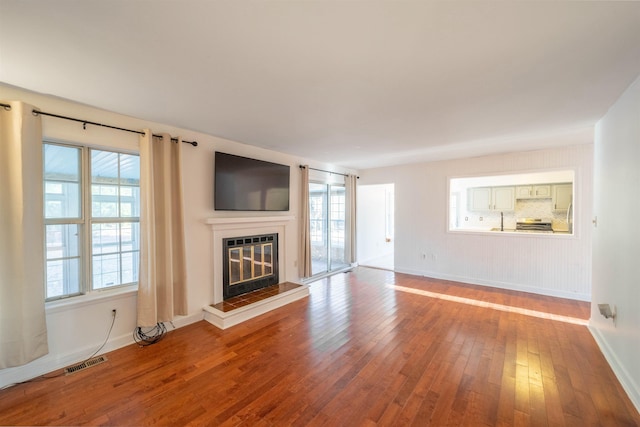 unfurnished living room featuring wood-type flooring