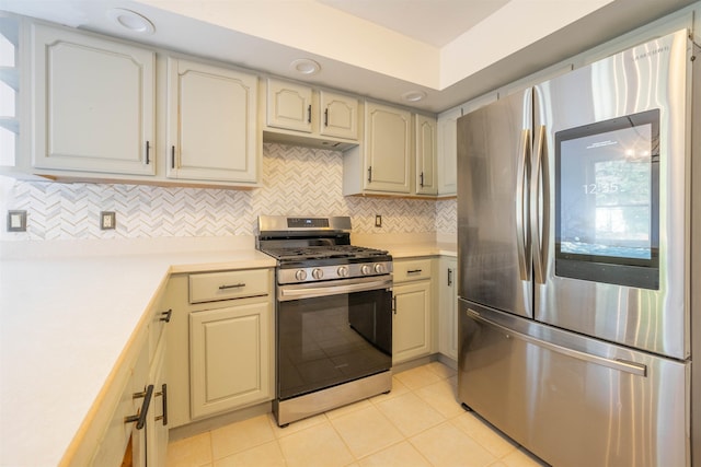 kitchen with backsplash, stainless steel appliances, and light tile patterned flooring