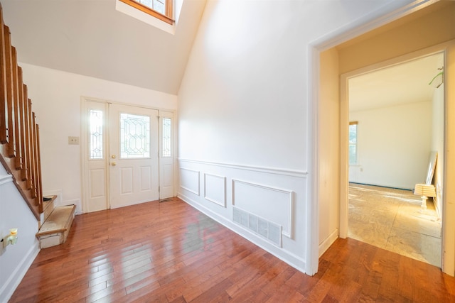 entryway featuring wood-type flooring and high vaulted ceiling