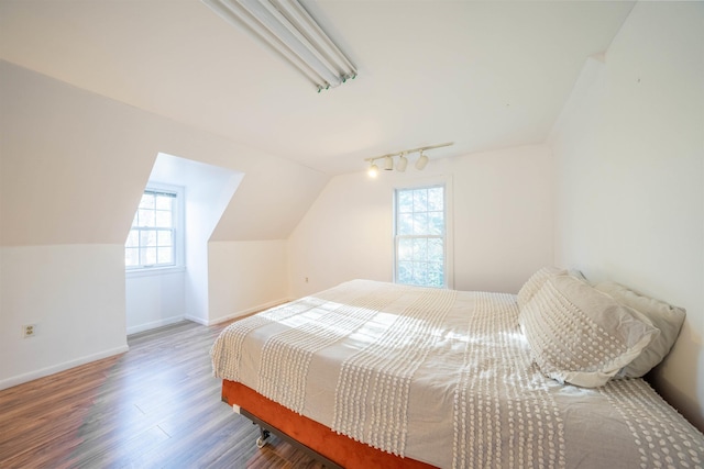 bedroom with hardwood / wood-style flooring and lofted ceiling