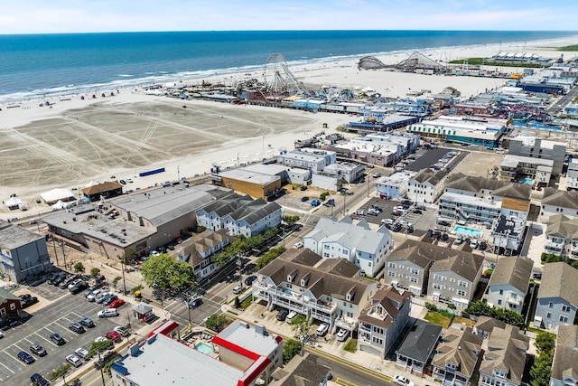 birds eye view of property with a beach view and a water view