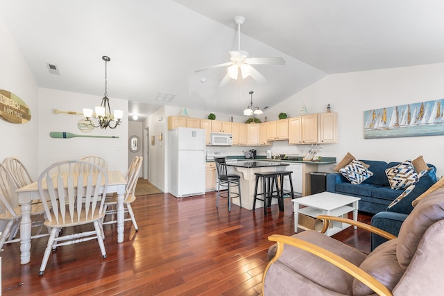 living room with ceiling fan with notable chandelier, dark hardwood / wood-style floors, and lofted ceiling