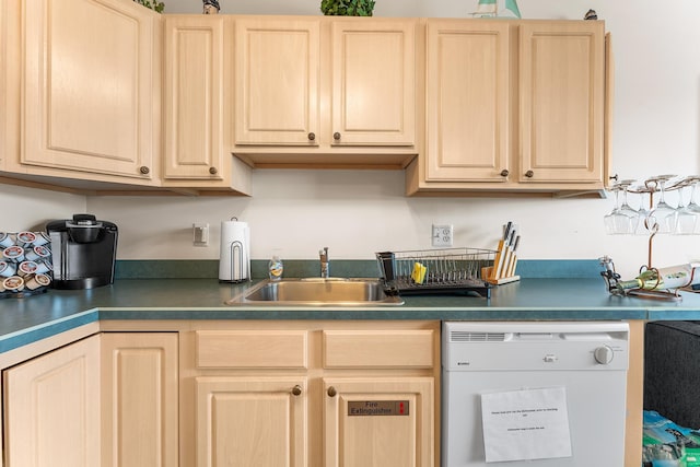 kitchen featuring light brown cabinetry, dishwasher, and sink