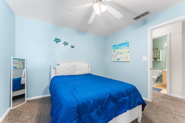 bedroom with dark colored carpet, ceiling fan, and connected bathroom