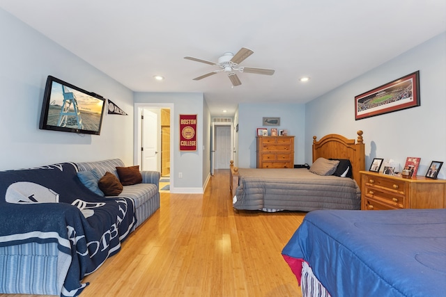 bedroom with wood-type flooring, ensuite bathroom, and ceiling fan