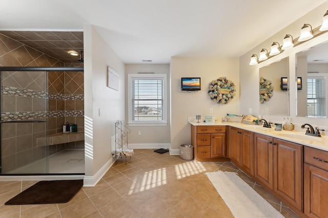 bathroom featuring tile patterned flooring, vanity, and an enclosed shower