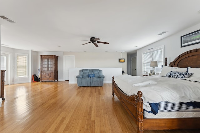 bedroom with multiple windows, light wood-type flooring, and ceiling fan