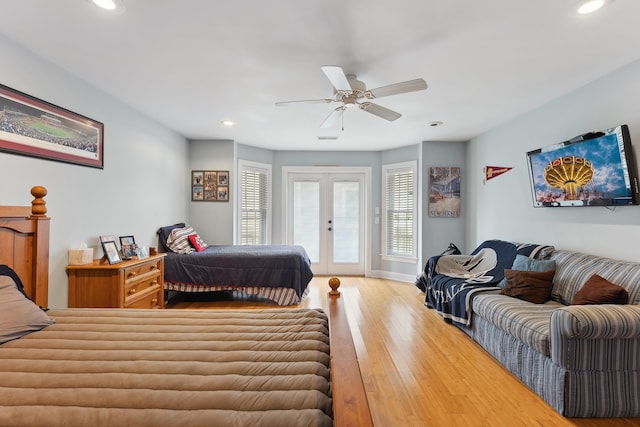 bedroom with access to exterior, ceiling fan, french doors, and hardwood / wood-style floors