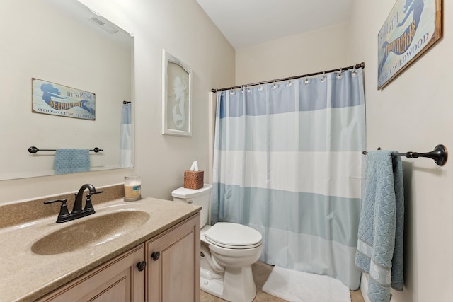 bathroom with vanity, toilet, and walk in shower