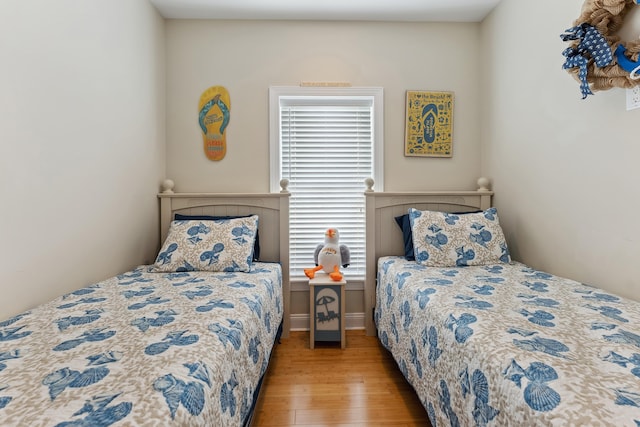 bedroom featuring multiple windows and hardwood / wood-style floors