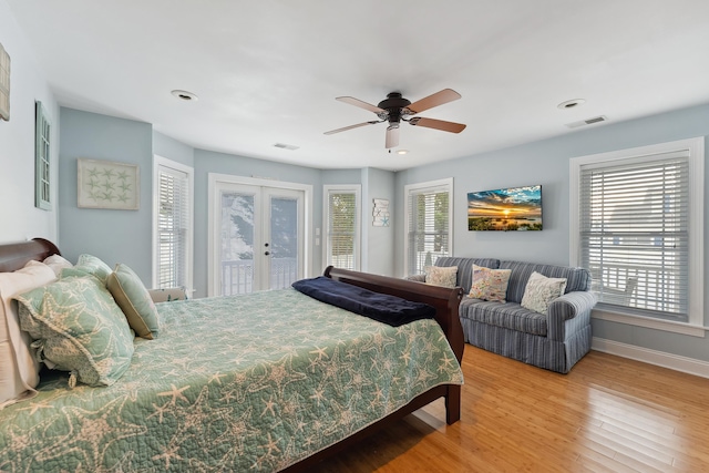 bedroom featuring french doors, access to outside, ceiling fan, and hardwood / wood-style flooring