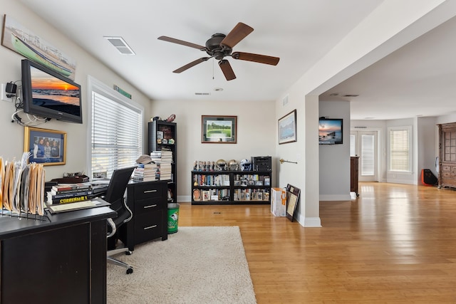 office space with ceiling fan and light hardwood / wood-style flooring