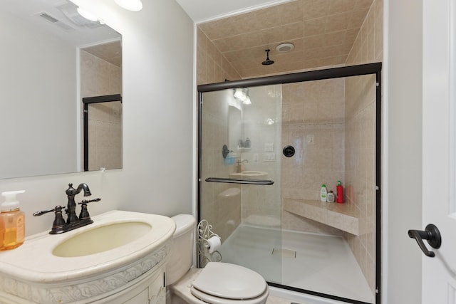 bathroom featuring vanity, toilet, and a shower with door