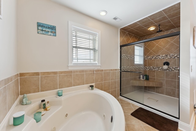 bathroom with tile patterned flooring and separate shower and tub