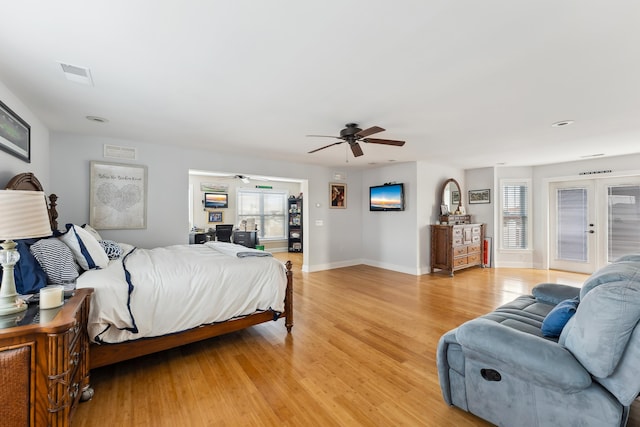 bedroom with french doors, light wood-type flooring, and ceiling fan