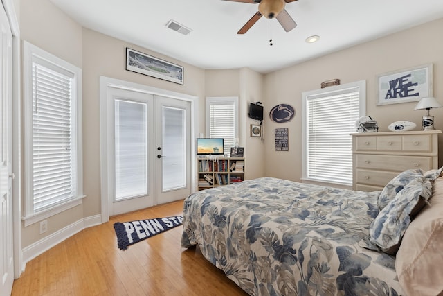 bedroom featuring access to outside, french doors, ceiling fan, multiple windows, and light hardwood / wood-style floors