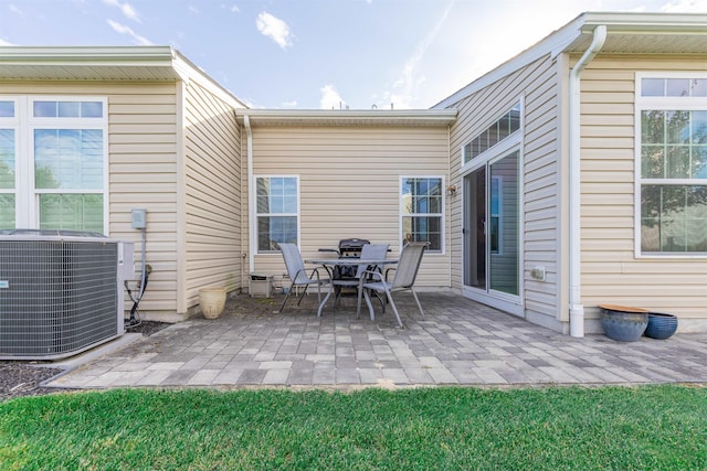 back of property featuring a patio and central air condition unit