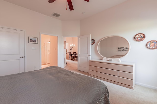 unfurnished bedroom featuring connected bathroom, ceiling fan, a towering ceiling, and light carpet