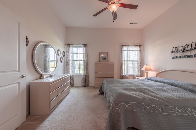 bedroom with light colored carpet and ceiling fan