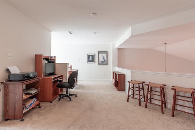 carpeted office featuring lofted ceiling