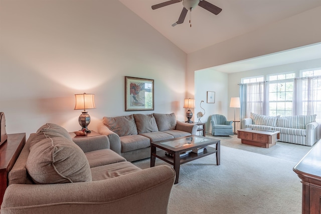 carpeted living room featuring ceiling fan and high vaulted ceiling