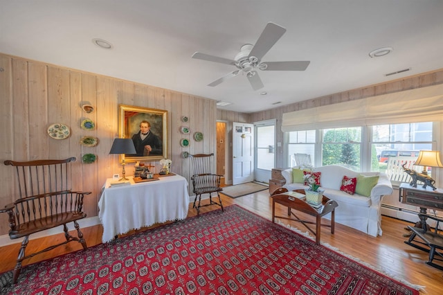 living room featuring ceiling fan and hardwood / wood-style flooring