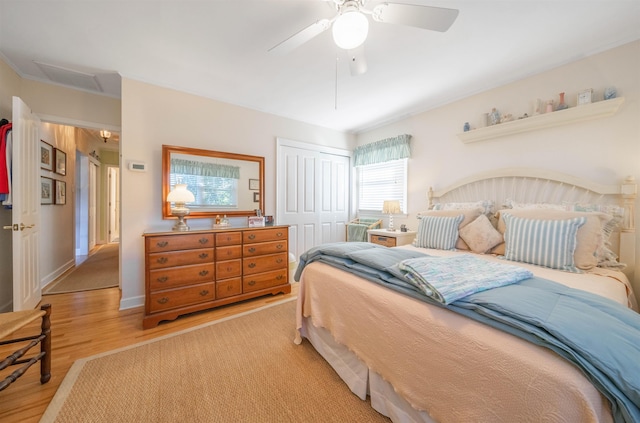 bedroom featuring light wood-type flooring, a closet, and ceiling fan