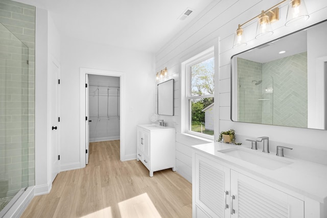 11 Oak Ave, Villas, NJ 08251 - full bathroom featuring a shower stall, a sink, visible vents, two vanities, and wood finished floors