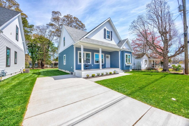 11 Oak Ave, Villas, NJ 08251 - view of front of home featuring covered porch, cooling unit, a front yard, and roof with shingles