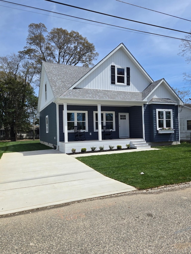 11 Oak Ave, Villas, NJ 08251 - view of front facade with covered porch, a front lawn, and roof with shingles