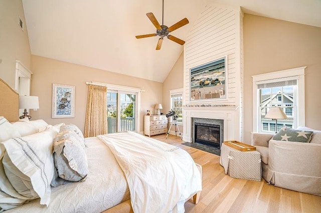 187 104th St, Stone Harbor, NJ 08247 - bedroom featuring high vaulted ceiling, access to exterior, a fireplace with flush hearth, light wood-style flooring, and a ceiling fan