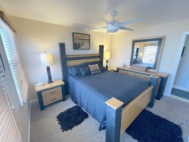 bedroom featuring baseboards, ceiling fan, and carpet