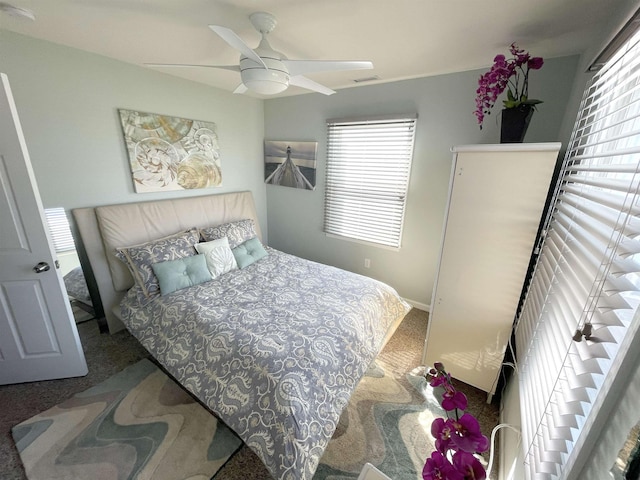 bedroom with visible vents, carpet, and ceiling fan