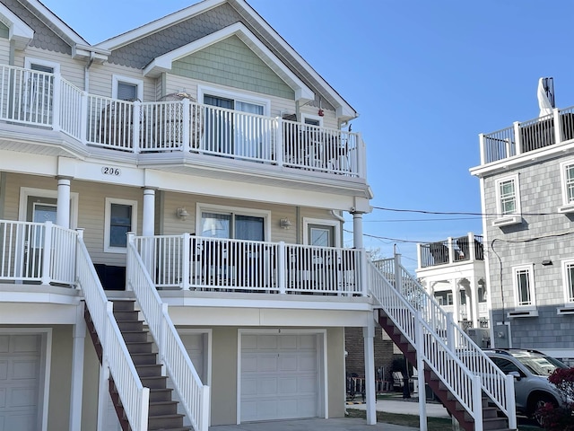 exterior space with a porch, stairs, and an attached garage