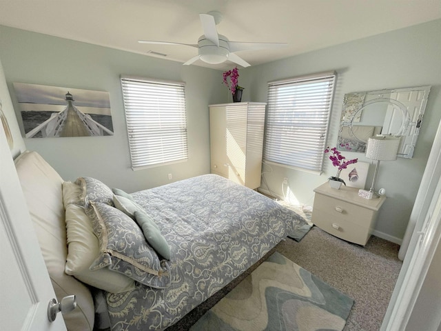 carpeted bedroom featuring visible vents and a ceiling fan