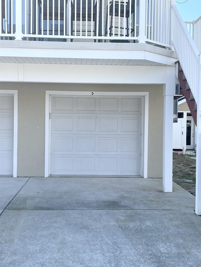 garage featuring concrete driveway