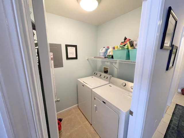laundry area with independent washer and dryer, light tile patterned floors, baseboards, and laundry area
