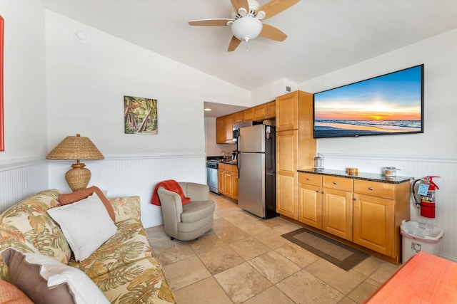 7929 Dune Dr Unit 310, Avalon, NJ 08202 - living area featuring a wainscoted wall, ceiling fan, lofted ceiling, and stone tile floors