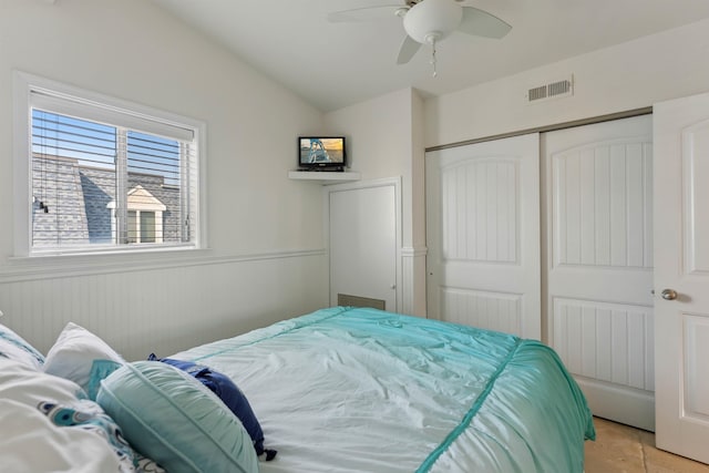 7929 Dune Dr Unit 310, Avalon, NJ 08202 - bedroom featuring a closet, light tile patterned floors, lofted ceiling, wainscoting, and a ceiling fan