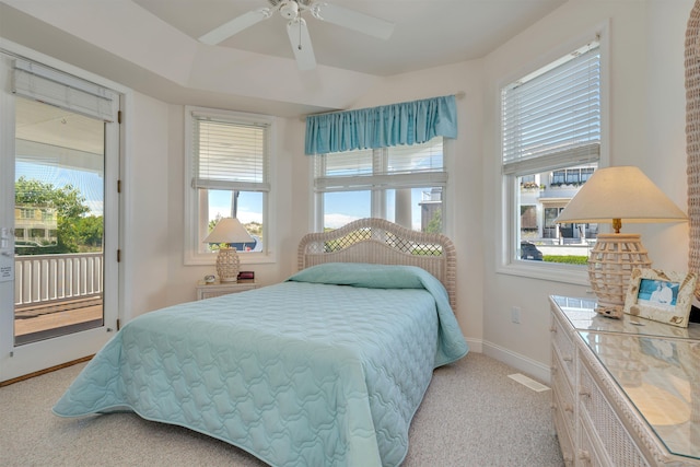 carpeted bedroom with ceiling fan and access to exterior