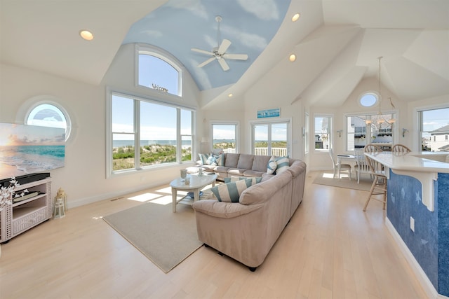 living room featuring ceiling fan, high vaulted ceiling, and light wood-type flooring