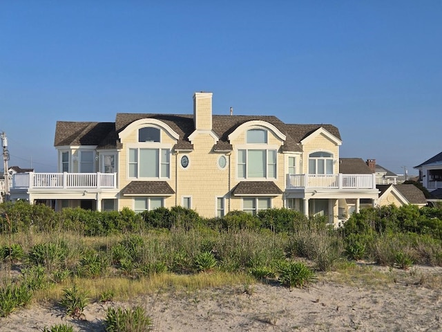 rear view of property with a balcony