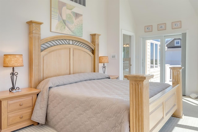 bedroom with access to exterior, light carpet, and vaulted ceiling