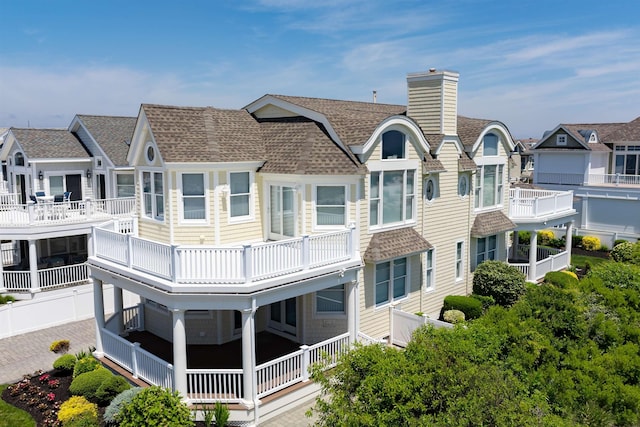 rear view of property featuring a balcony